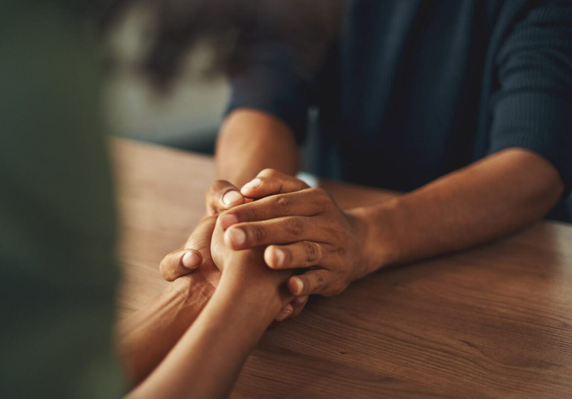 Bereaved people consoling each other.